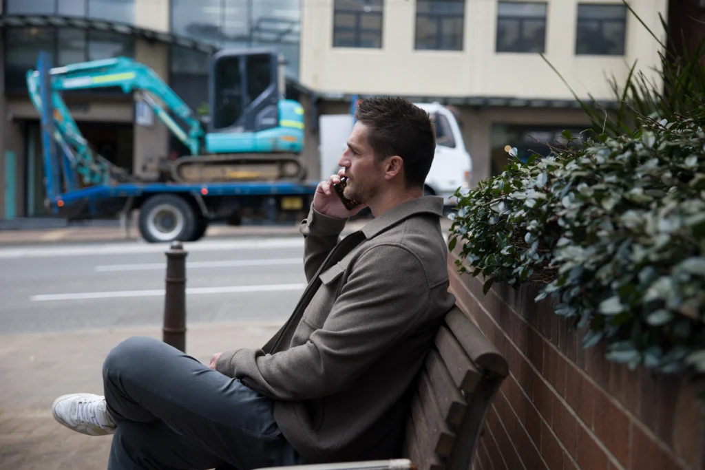 MartinCo agent on phone call by street.