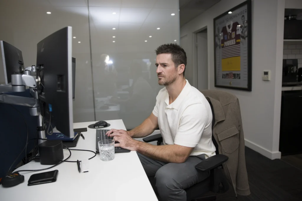MartinCo professional typing at an office desk.