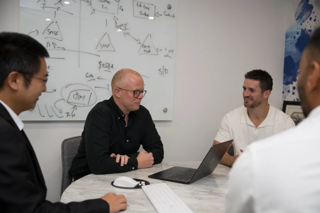 MartinCo professionals collaborating in meeting room.